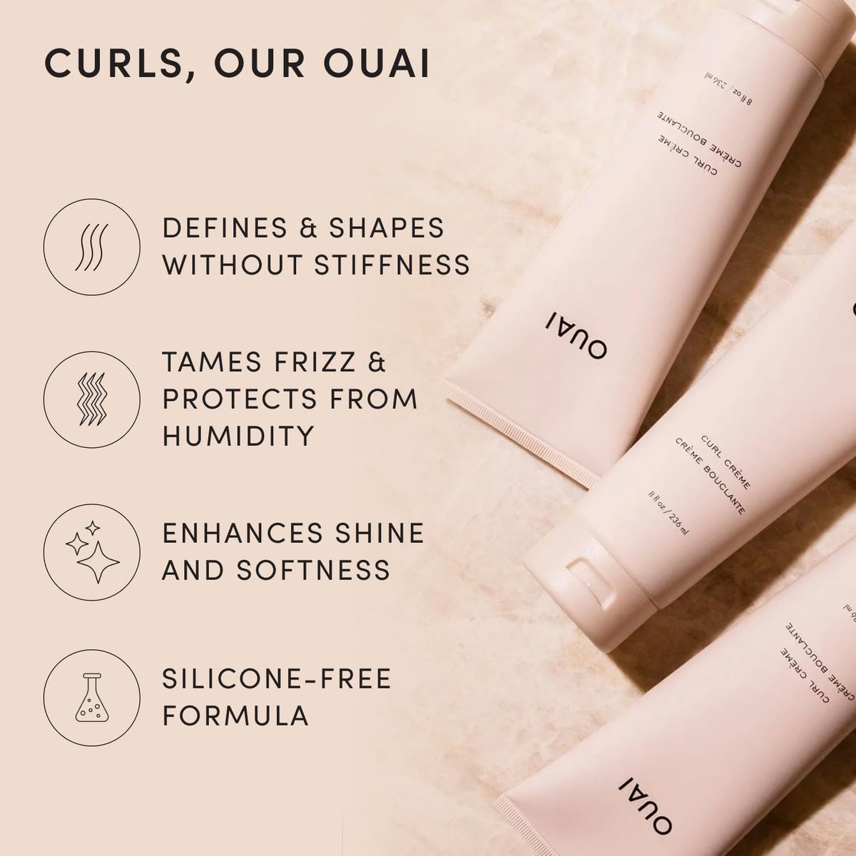 OUAI curl cream dispensing from tube onto fingers for easy styling control and measured use