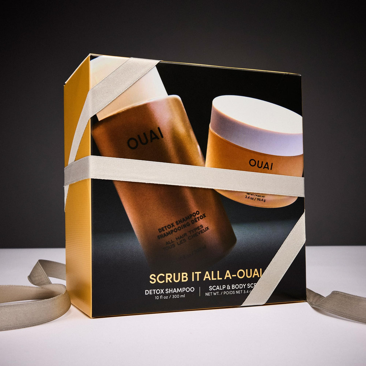 OUAI travel exfoliating scrub tube displayed for convenient on-the-go scalp care