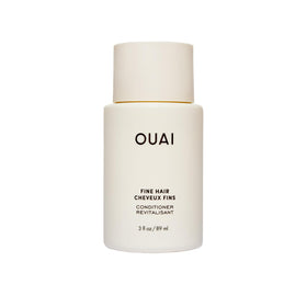 OUAI front packaging of travel conditioner showing bottle and branding, easy-packing benefit