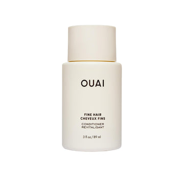 OUAI front packaging of travel conditioner showing bottle and branding, easy-packing benefit