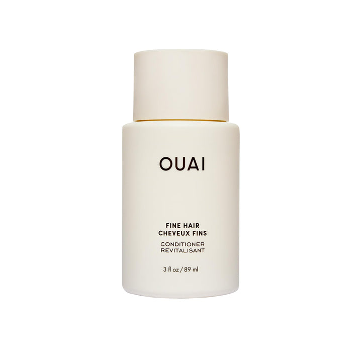 OUAI front packaging of travel conditioner showing bottle and branding, easy-packing benefit