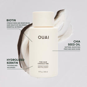 OUAI travel conditioner next to passport showing compact 3 oz size for carry-on convenience