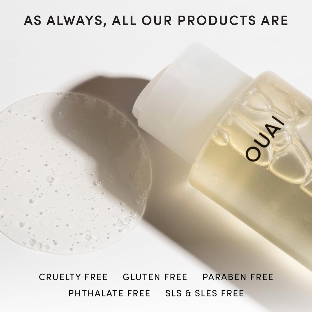 OUAI hands applying shampoo to wet hair showing root-to-end coverage