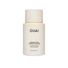 OUAI medium conditioner front tube showing compact travel-friendly design and benefits