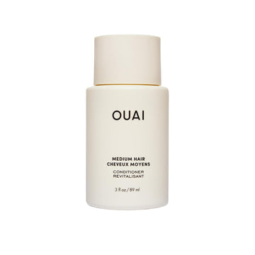 OUAI medium conditioner front tube showing compact travel-friendly design and benefits