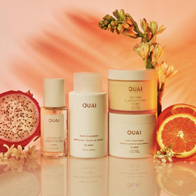 OUAI set tucked in a beach bag evoking tropical vacation-ready fragrance