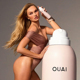 OUAI in a travel setting showing quick touch-up use between flights and days out