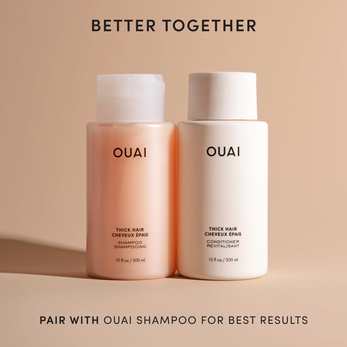 OUAI 32 oz refill next to a hand to show large palm-scale capacity