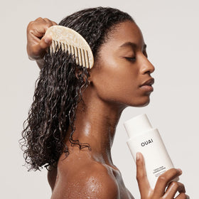 OUAI refill pouring into bottle to show easy transfer and refill benefit