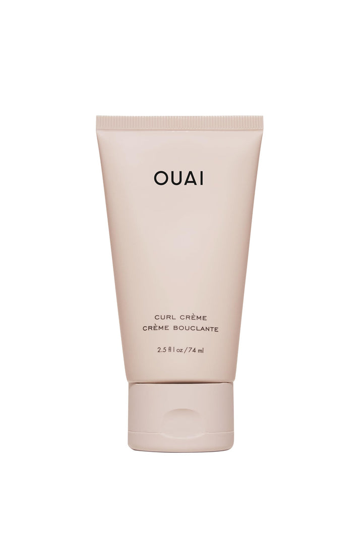 OUAI travel curl cream front tube showing compact travel-friendly packaging and portability