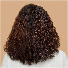 ouidad product being raked through damp curls for defined styling benefit