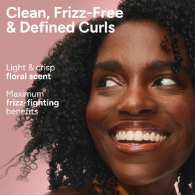 Ouidad hands applying shampoo to wet curls showing improved manageability benefit