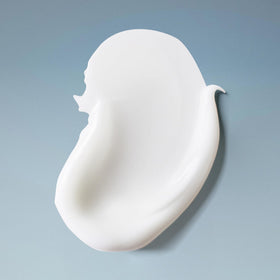 Ouidad shampoo lather on wet curly hair showing gentle cleansing benefit