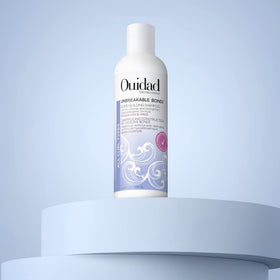 Ouidad shampoo in bright bathroom lifestyle image for sensitive-scalp friendly routine