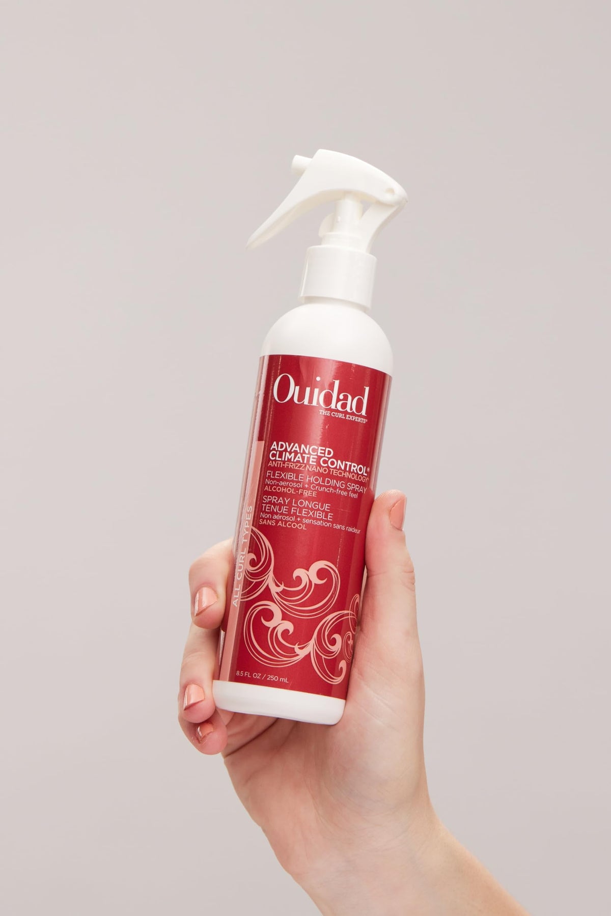 Ouidad size scale hand-held to show bottle dimensions and portability