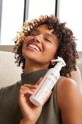 Ouidad spray nozzle close up demonstrating easy even application benefit