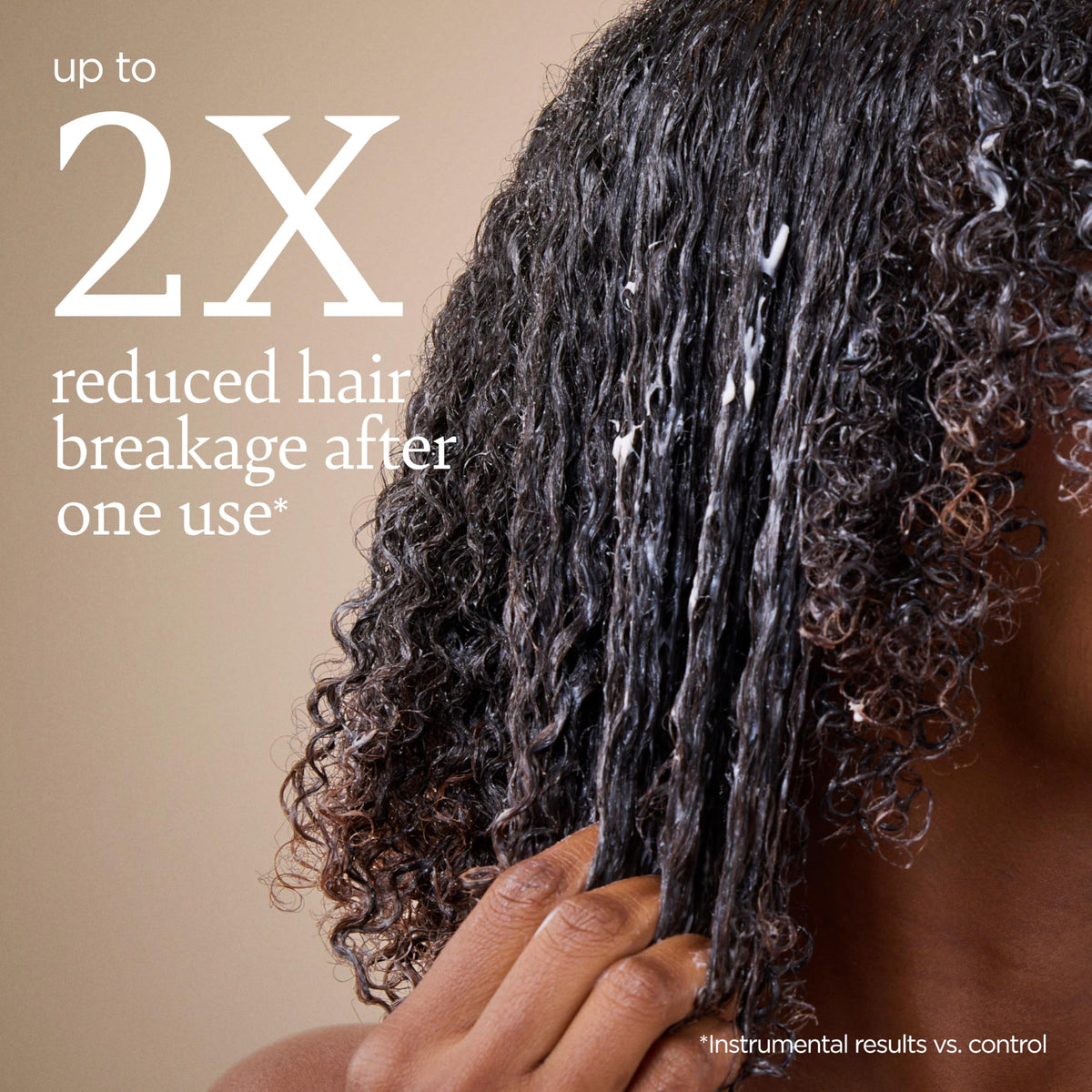 Ouidad styled curls in bathroom scene showing salon-ready bounce