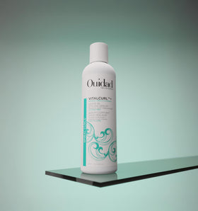 Ouidad VitalCurl pump dispensing a drop of serum for controlled application benefit