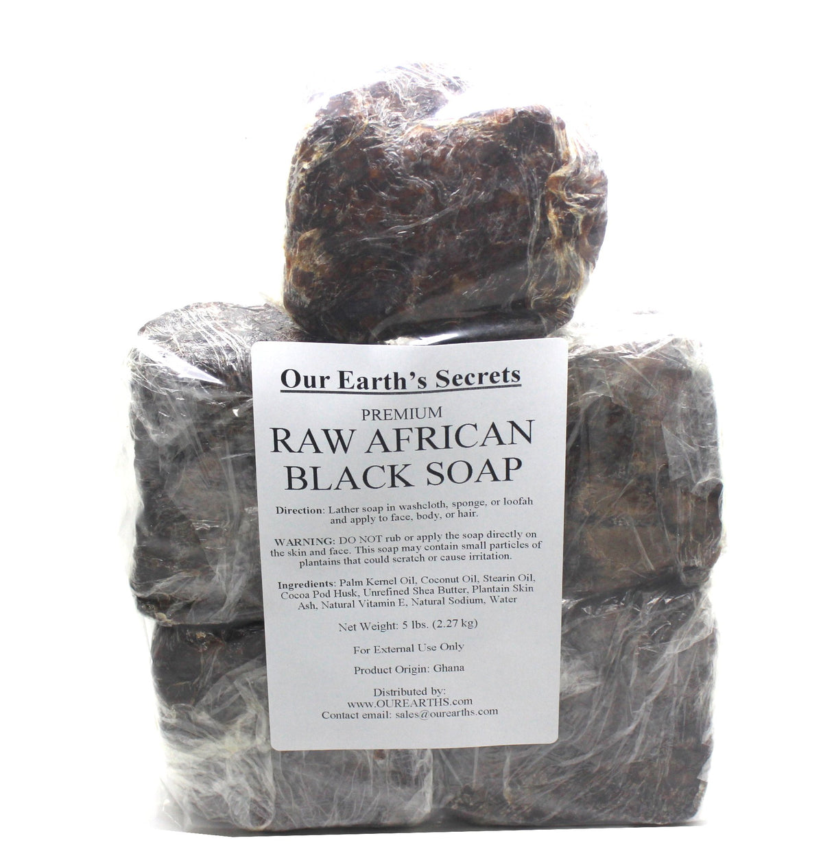 Our Earth's Secrets close-up of soap texture and cocoa ash flecks, highlighting artisanal raw formulation benefit