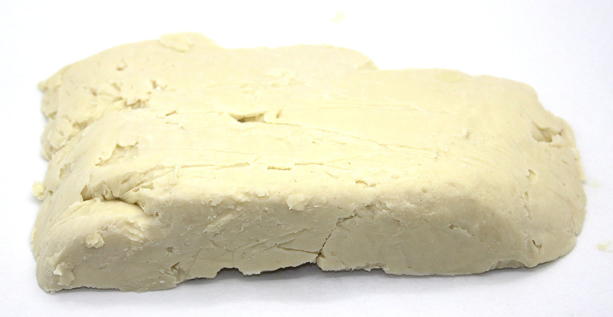 Our Earth's Secrets shea butter hand-cut detail showing artisan preparation and care