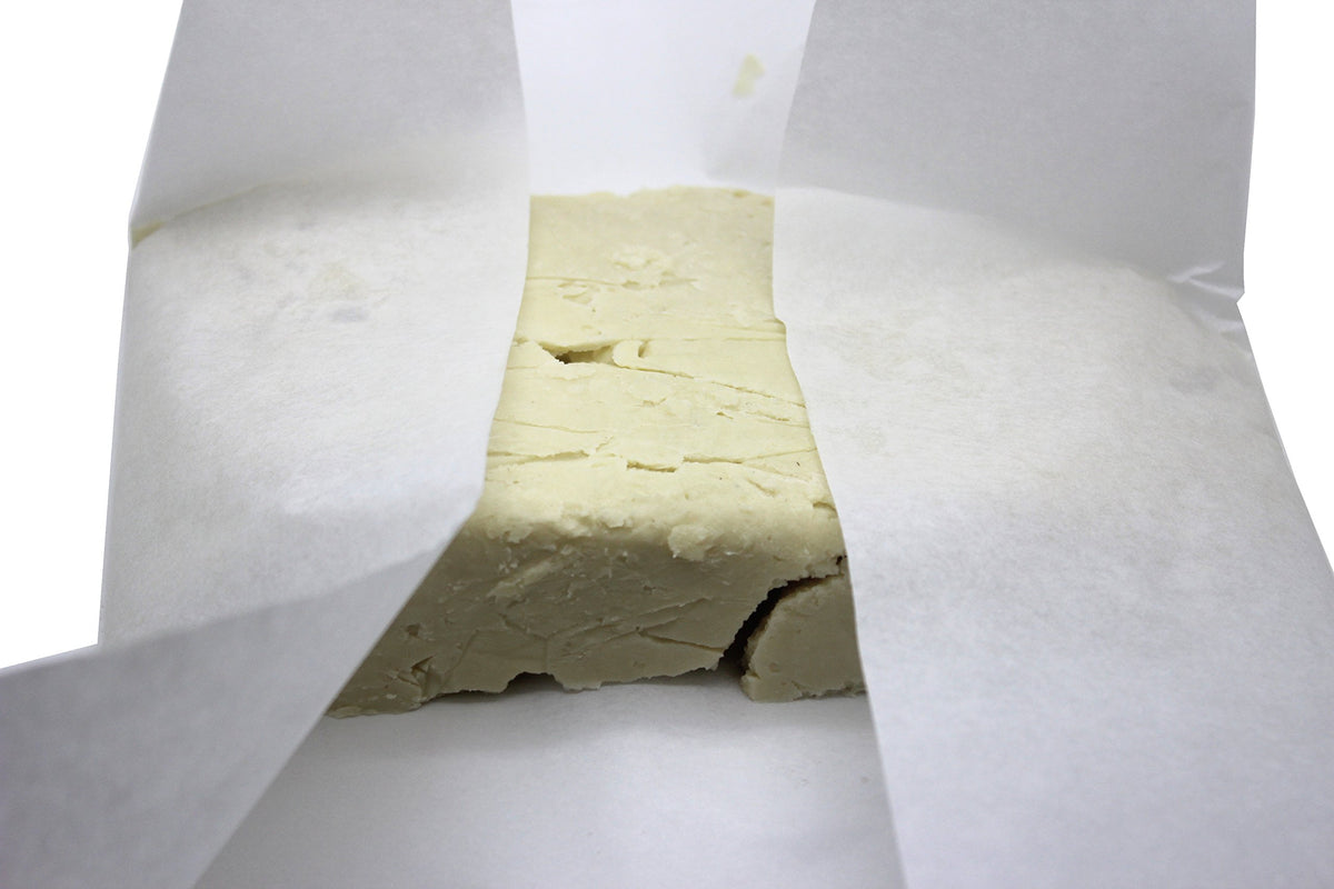 Our Earth's Secrets butter being applied to hands demonstrating smooth melt and moisturization benefit
