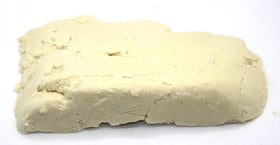 Our Earth's Secrets close-up revealing creamy raw shea butter texture and purity benefit
