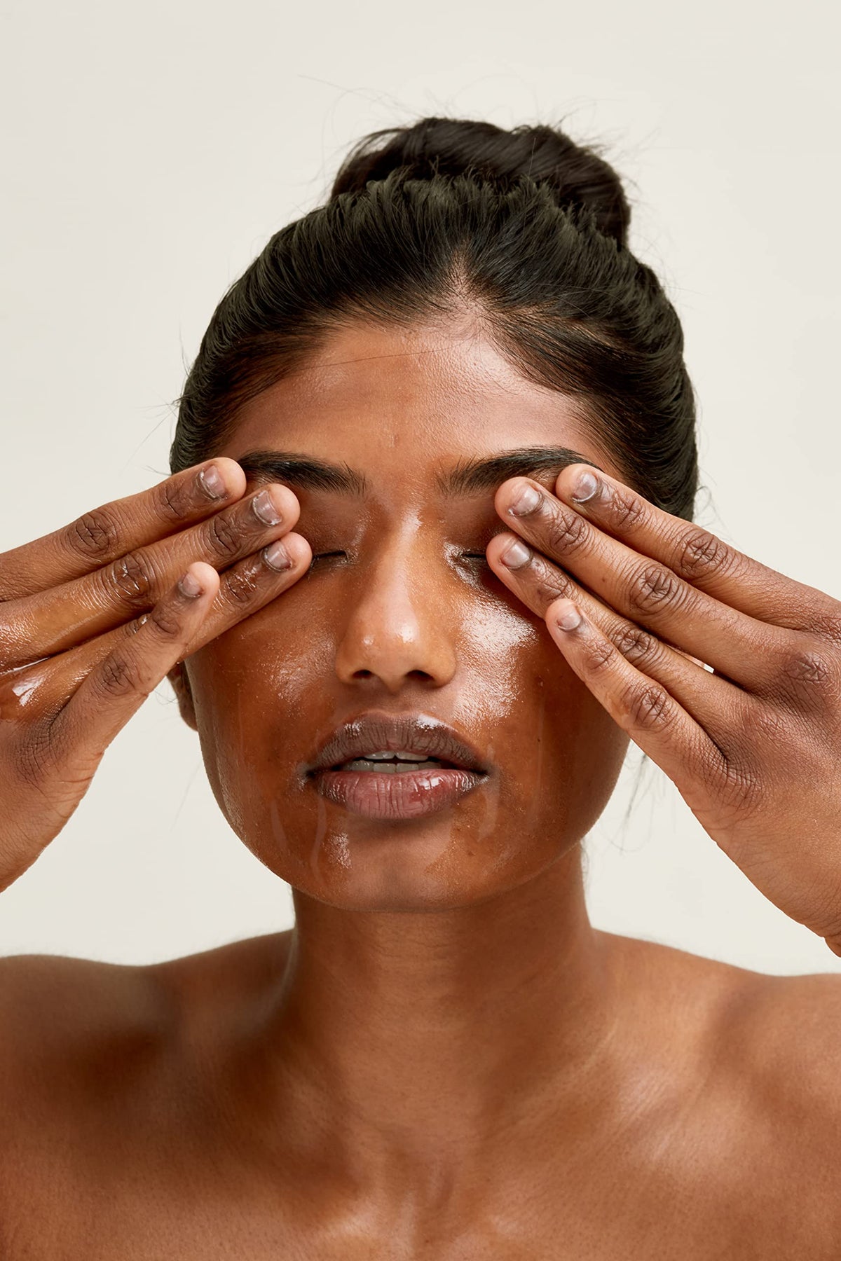 PAI SKINCARE 100ml bottle next to hand showing true size and travel-friendly benefit