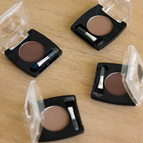 Palladio compact in hand showing size for purse and travel portability