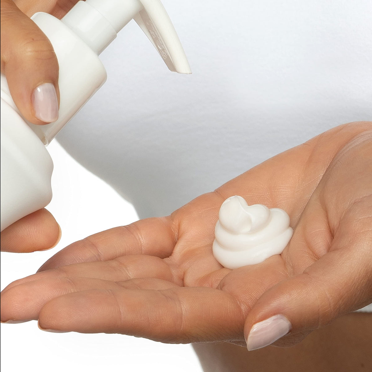 Palmer's lotion swiped on skin, displays creamy texture and smoothing benefit