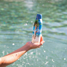 Person applying Panama Jack at the beach demonstrating outdoor sun protection