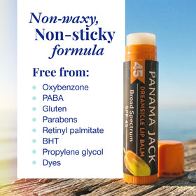 Panama Jack dreamsicle tube held over sand illustrating beach-ready sun protection