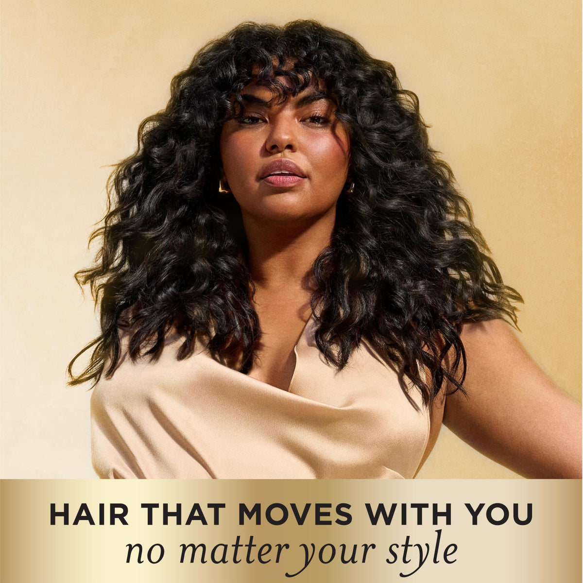 Pantene curl mousse being applied to damp curls for defined shape