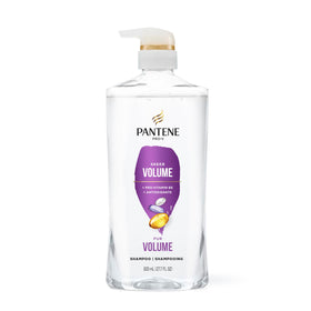 Person styling hair after using Pantene for visible fuller blowout
