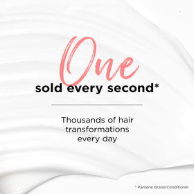 Pantene bottles in hand to show 17.9 oz scale and travel readiness