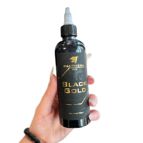 Panthera Black Gold ink being applied with a tattoo machine showing reliable performance