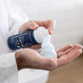 Particle bottle in a hand for scale and travel-friendly benefit
