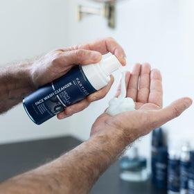 Particle bottle on shower shelf illustrating daily in-shower convenience