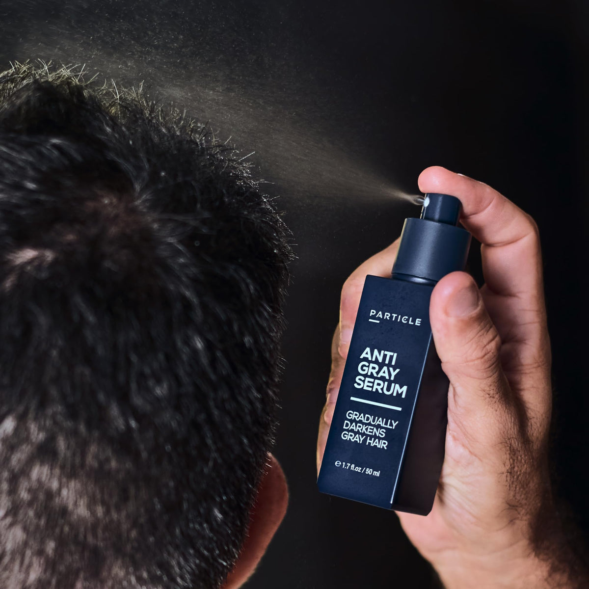 Particle bottle in hand to show size, conveying portability and daily use ease