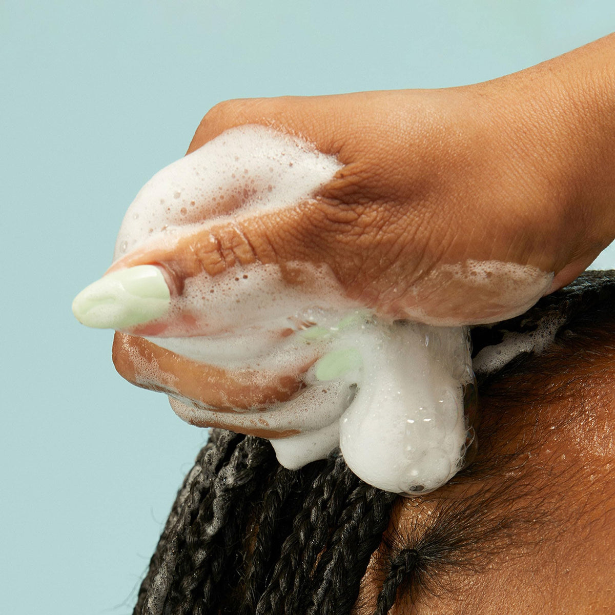 PATTERN styling hand scrunching curls to show enhanced definition and volume
