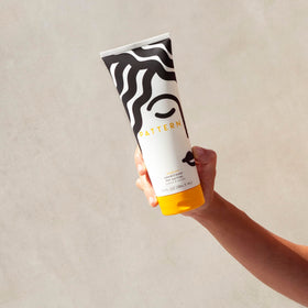 PATTERN conditioner in hand demonstrating slip and detangling ease for curls