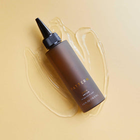 PATTERN scalp serum on bathroom shelf styled with towel showing daily routine ease and refreshed scalp benefit