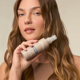 Paul Mitchell bottle beside mirabelle plums to emphasize botanical ingredient benefit