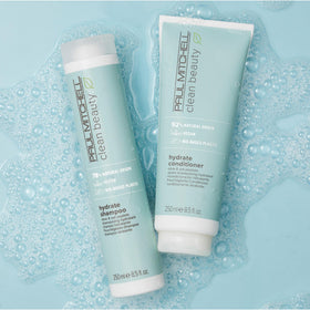 Paul Mitchell bottle in hand showing size and eco-conscious packaging benefit