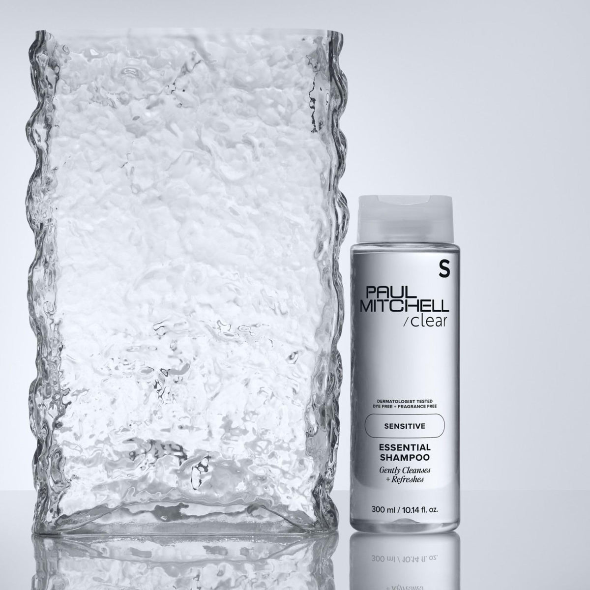 Paul Mitchell bottle on vanity with color-treated hair showcasing color-safe benefit
