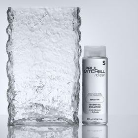 Paul Mitchell bottle on vanity with color-treated hair showcasing color-safe benefit