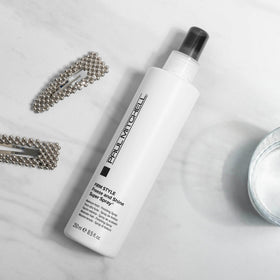 Paul Mitchell bottle in hand showing 3.4 fl oz size and portability