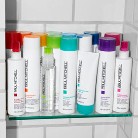 Paul Mitchell being sprayed by stylist demonstrating in-salon use and protective benefit