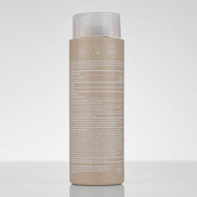 Paul Mitchell shampoo on bathroom shelf in a calming setting