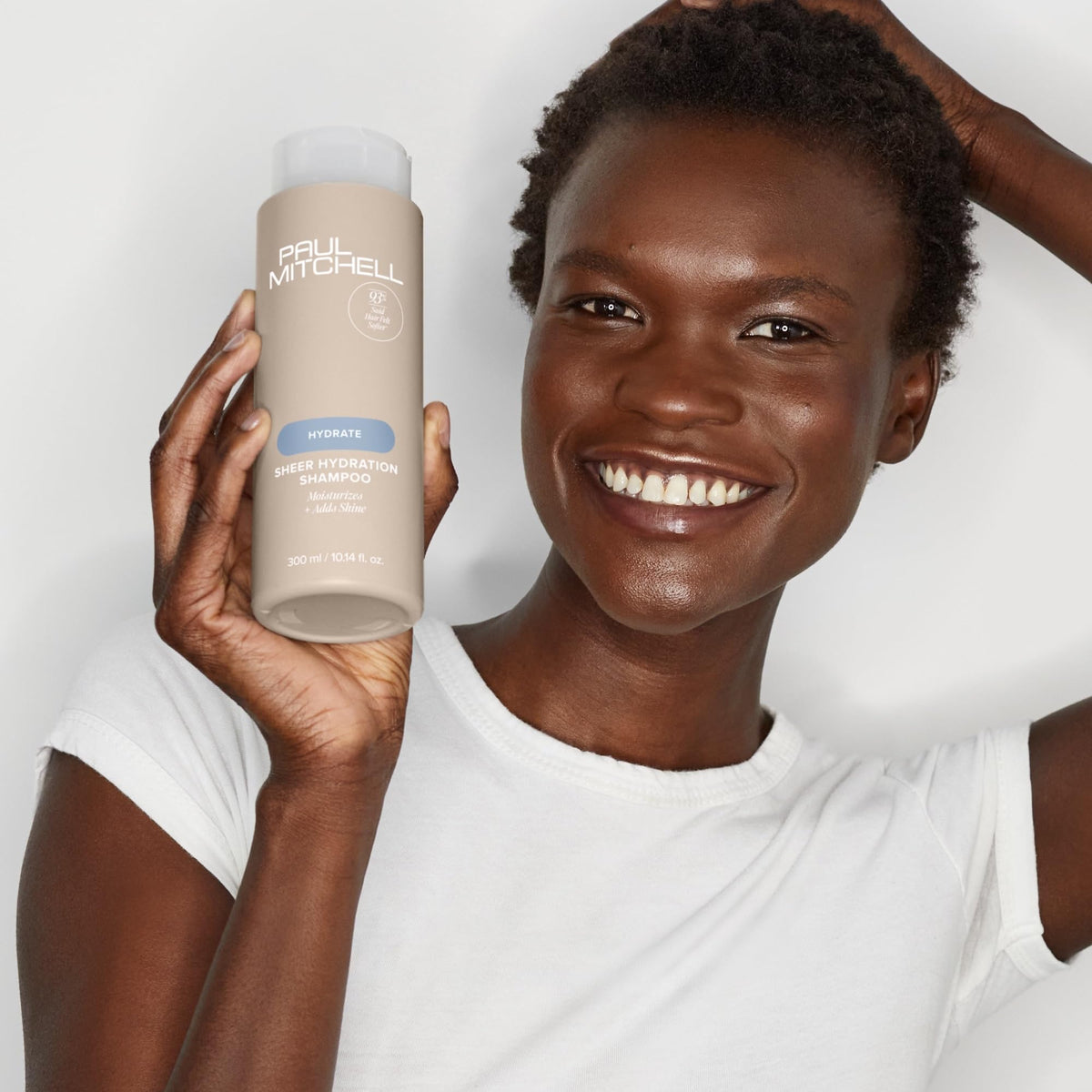 Paul Mitchell shampoo being applied in shower for soft hair benefit