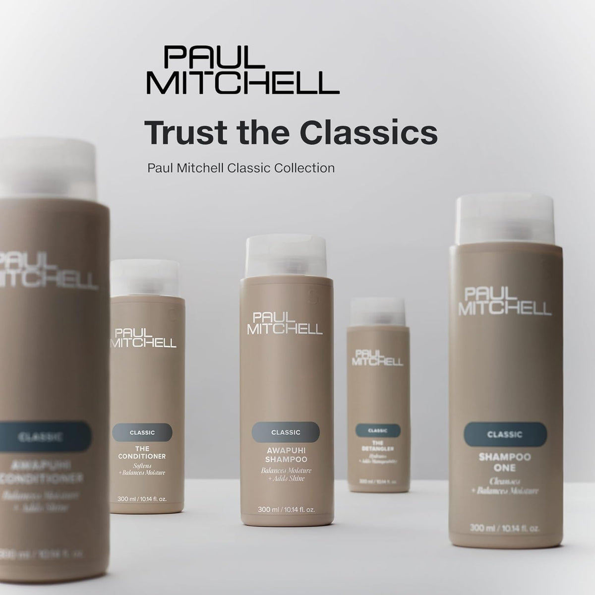 Hand holding Paul Mitchell bottle to show 16.9 fl oz scale and portability